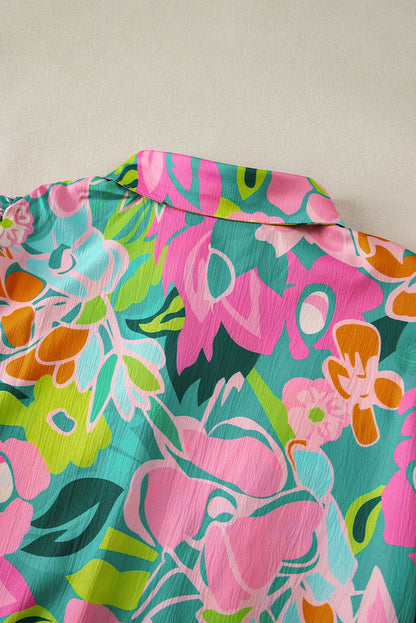 Close-up of the buttoned front detail on the green floral babydoll dress.