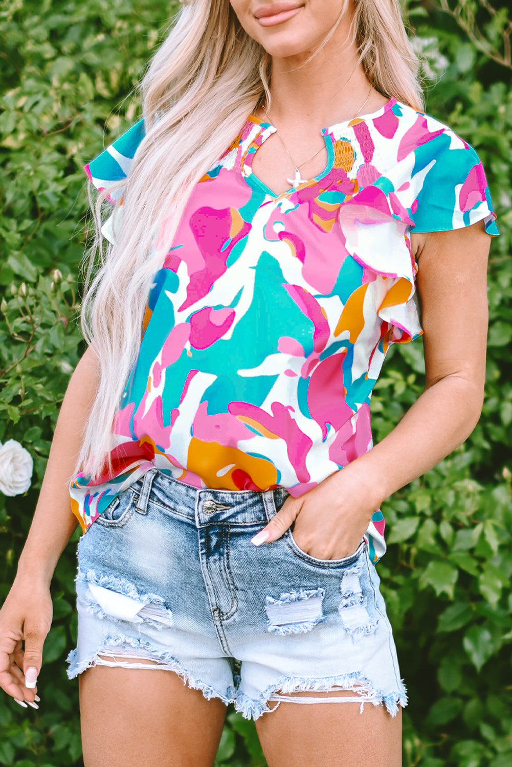 Close-up of the back of the multicolour abstract print blouse, showcasing the smocked design