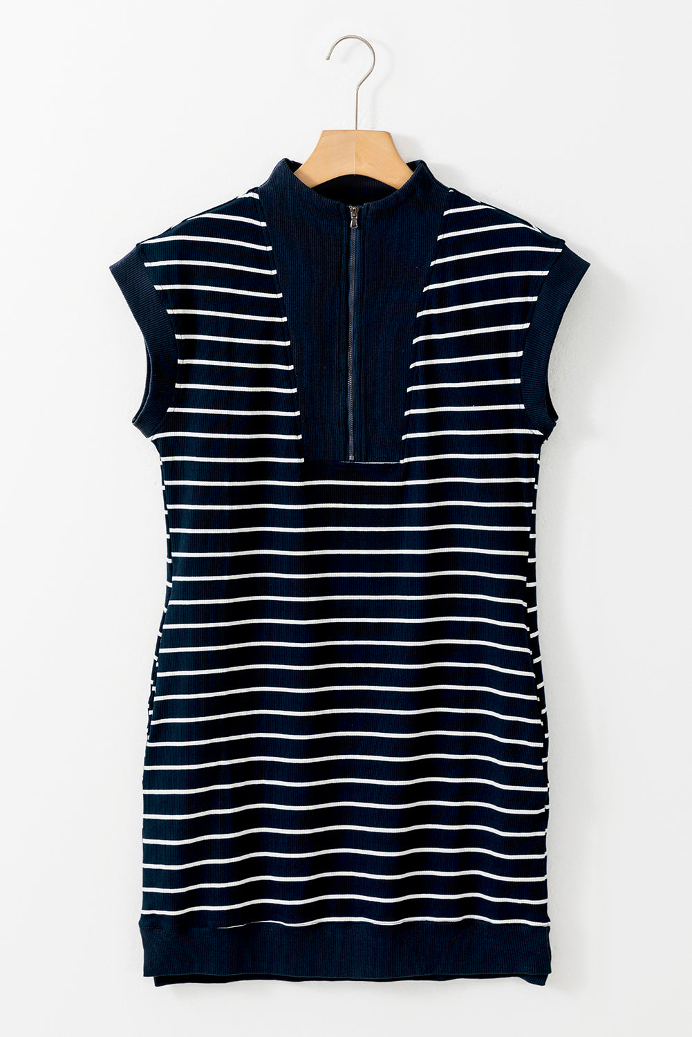 Close-up of the stylish split detail at the hem of the navy blue striped mini dress.