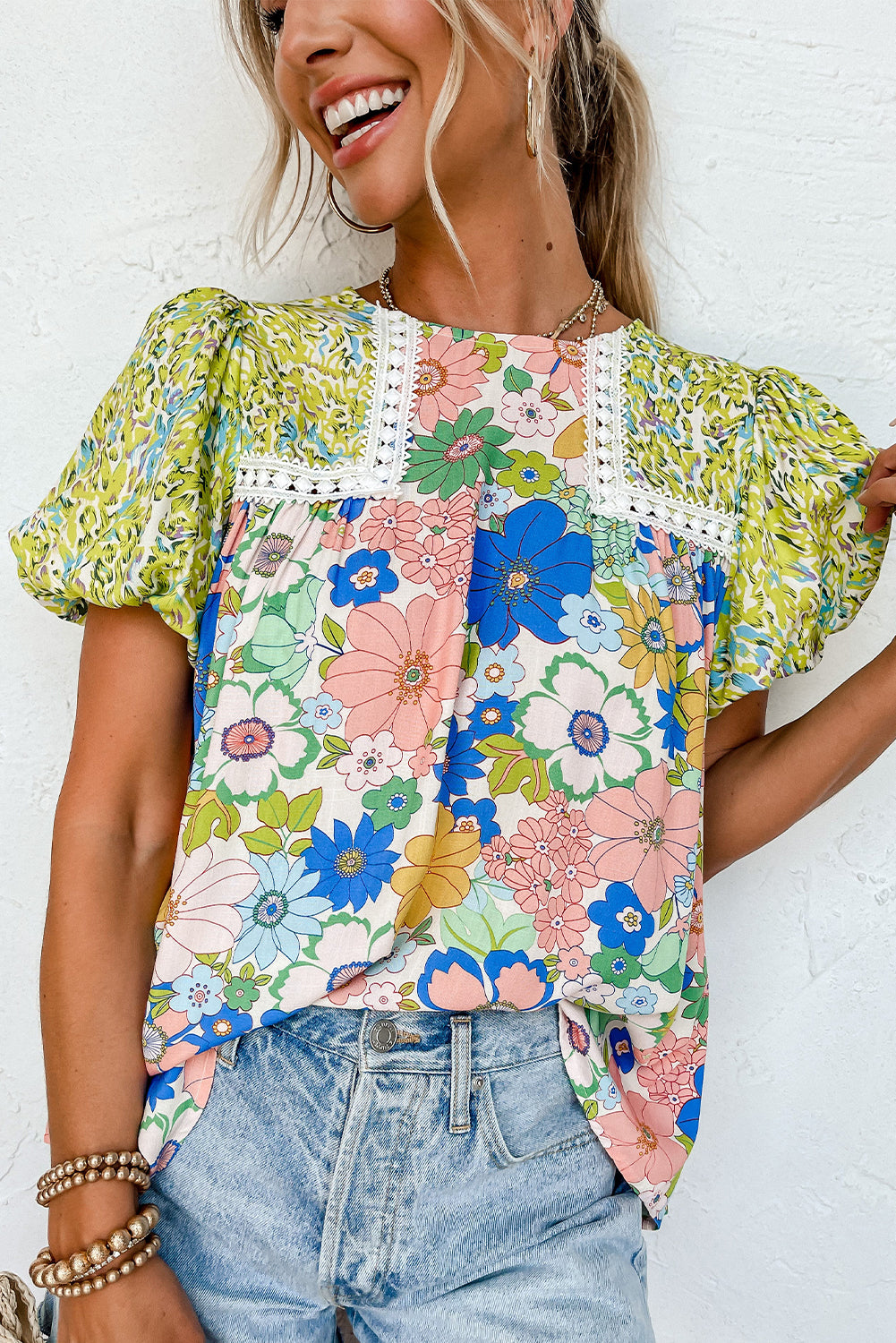 Green blouse with bubble sleeves, lace trim, and a mixed floral print (women's clothing).