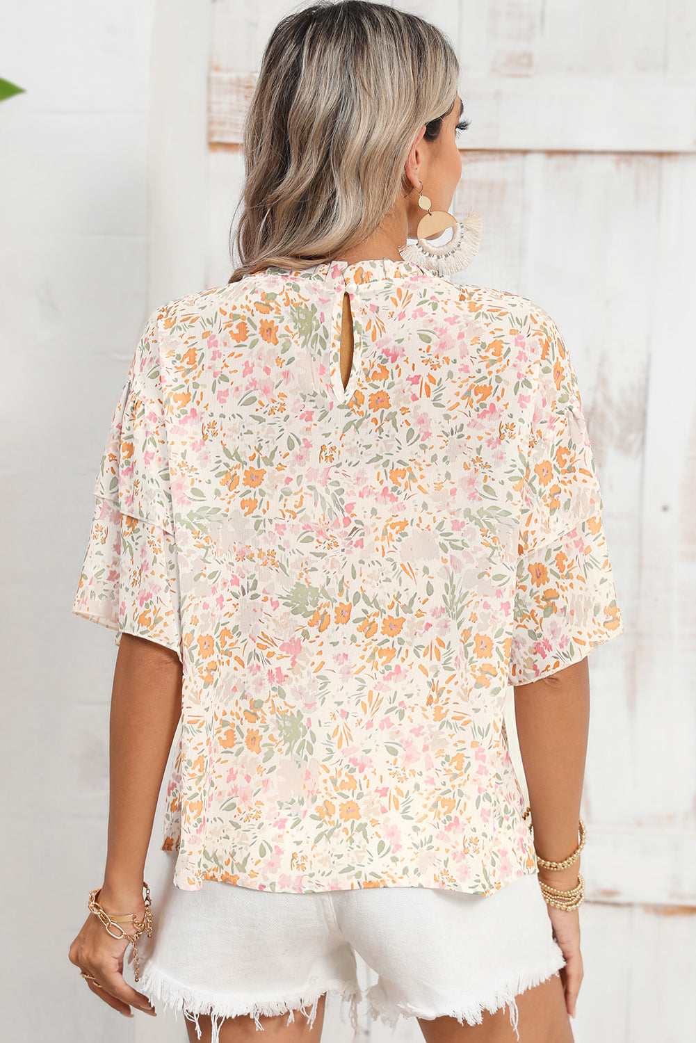 Close-up of the vibrant floral design in various colors on the blouse.