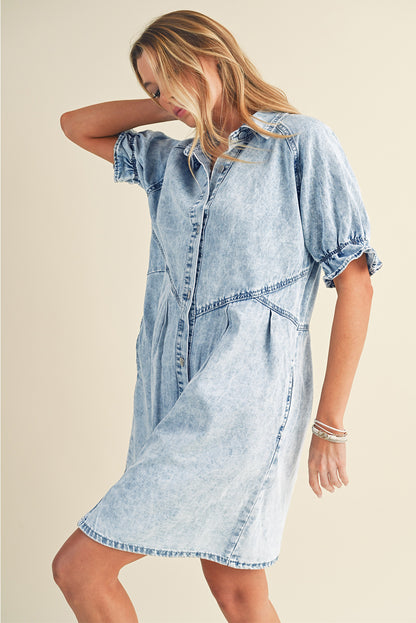 Model wearing a blue mineral washed denim dress with ruffled short sleeves and pockets