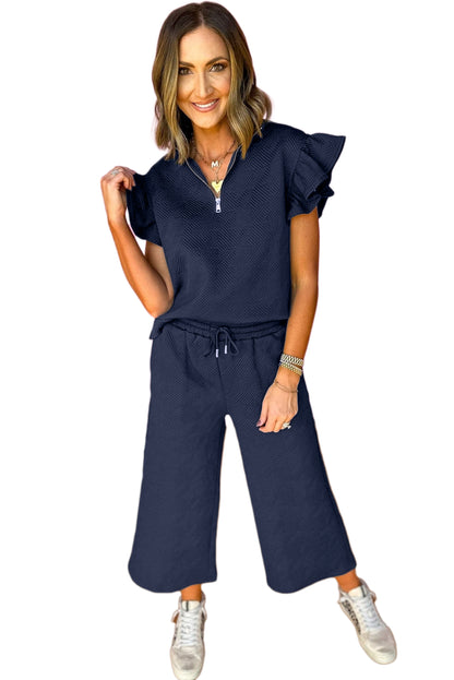 Black textured ruffle cap sleeve top and wide-leg pants set: upgrade your wardrobe with a chic and comfortable outfit!