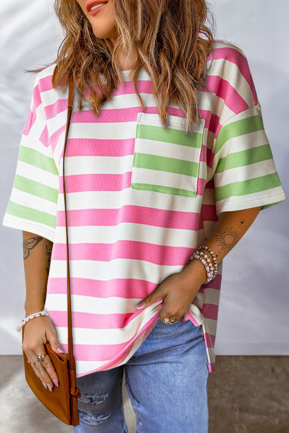 Close-up of the drop sleeve detailing on the pink striped t-shirt.