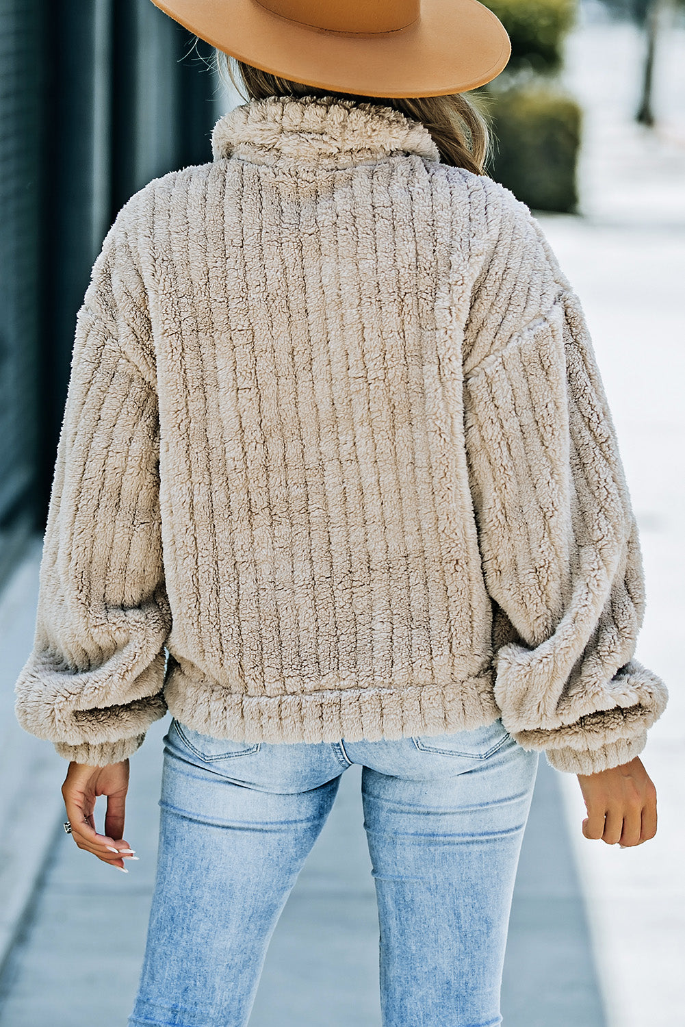 Close-up of the soft and plush khaki fleece material of the jacket.