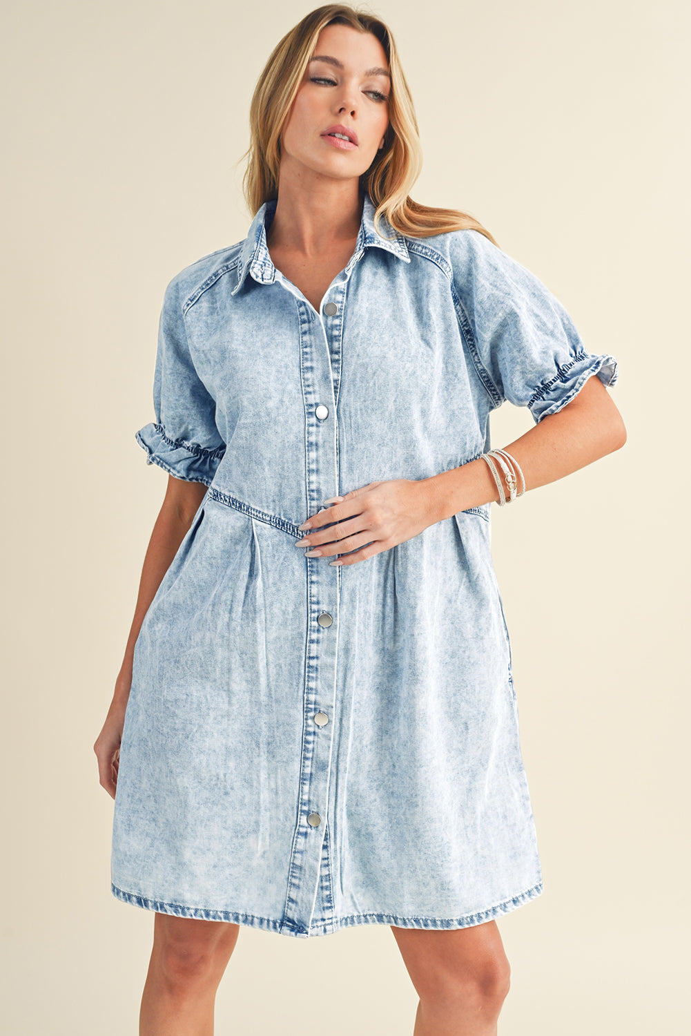 Blue mineral washed denim dress with ruffled short sleeves and pockets styled for a casual outing.