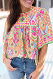 Orange geometric print blouse with bell sleeves and a babydoll silhouette (women's top).