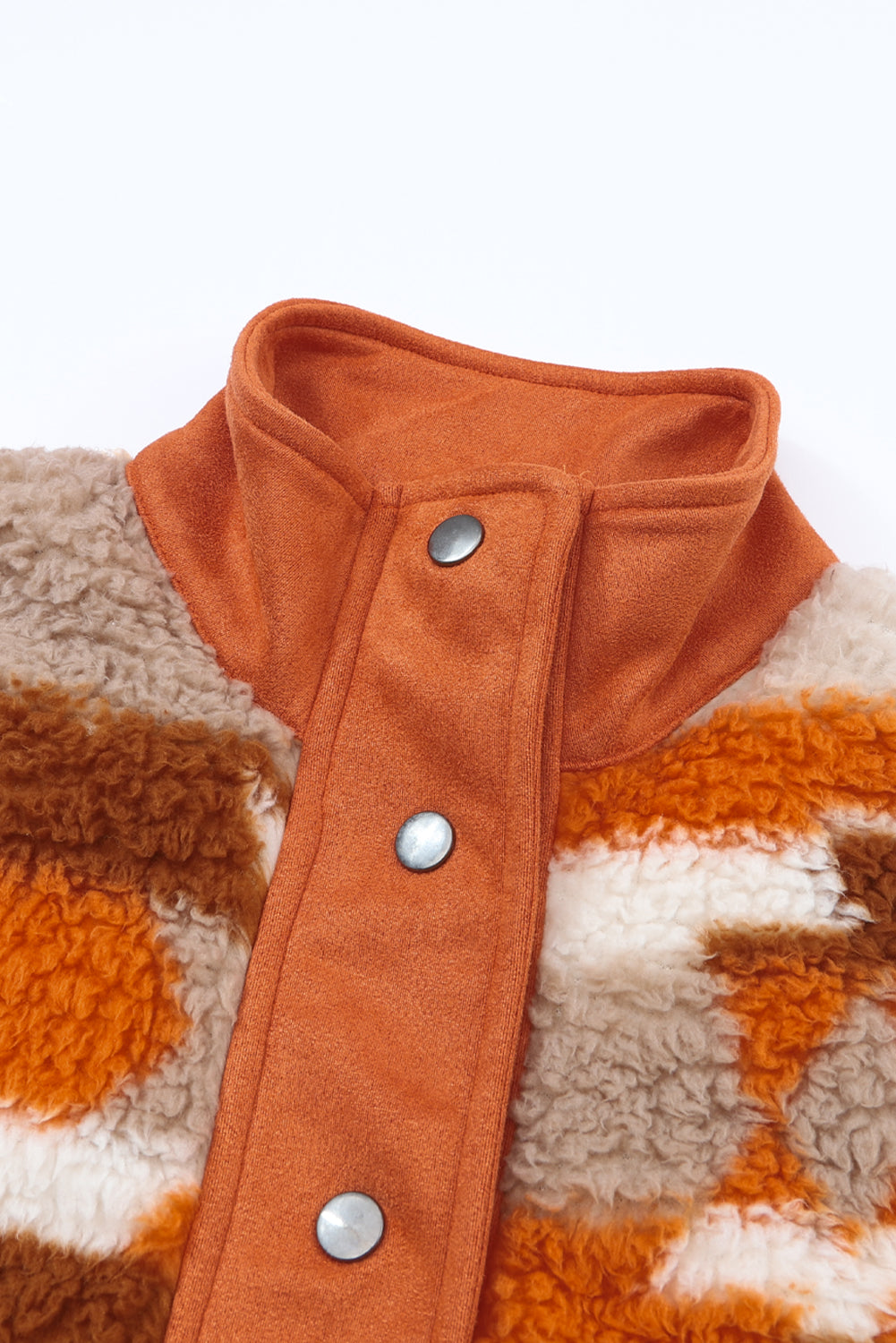 The quilted patch pockets add a touch of style and functionality to the brown striped and geometric fleece jacket (close-up).