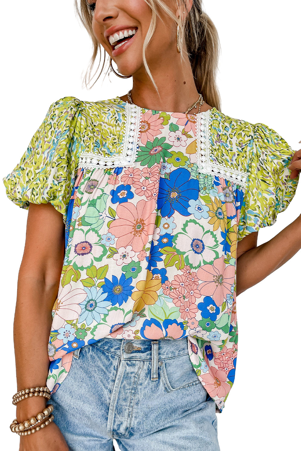 Green bubble sleeve lace trim mixed floral blouse hanging neatly on a hanger.