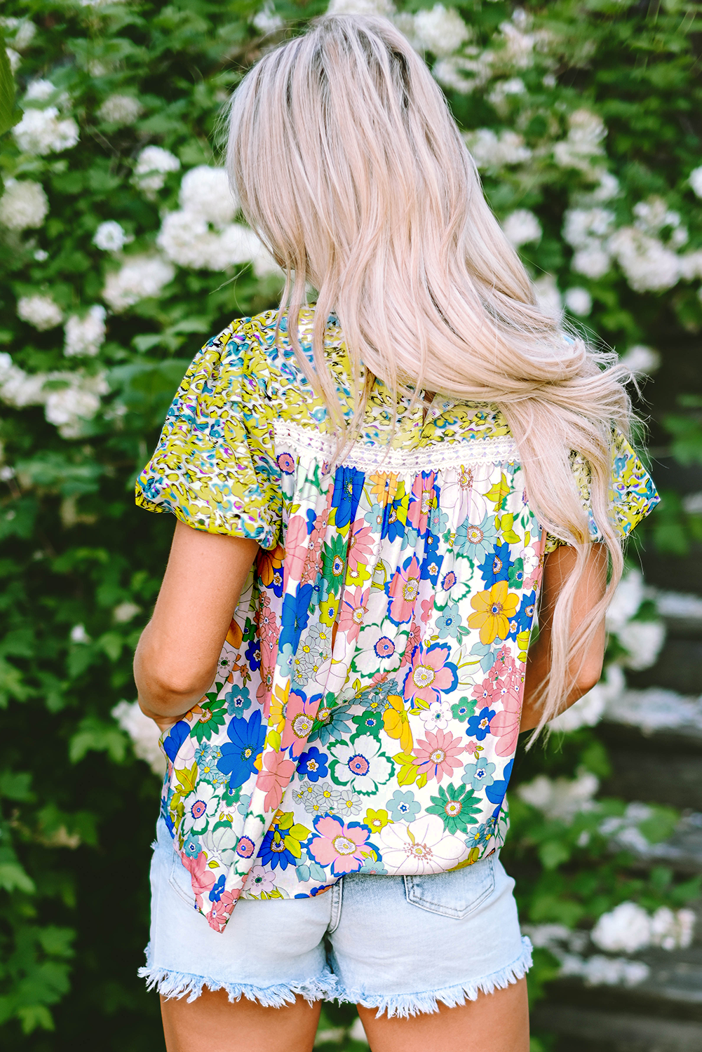 Close-up of the comfortable bubble sleeves on the green floral blouse.