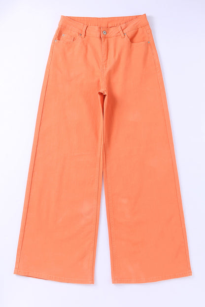 Close-up of the zip fly and button closure on the orange acid wash jeans.