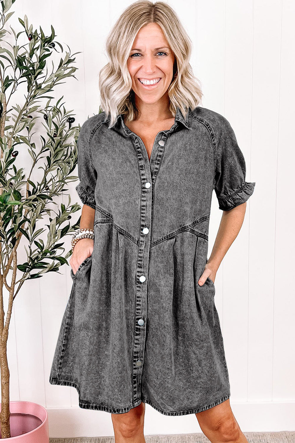 Layer the blue mineral washed denim dress with ruffled short sleeves and pockets with a cardigan for cooler weather. 