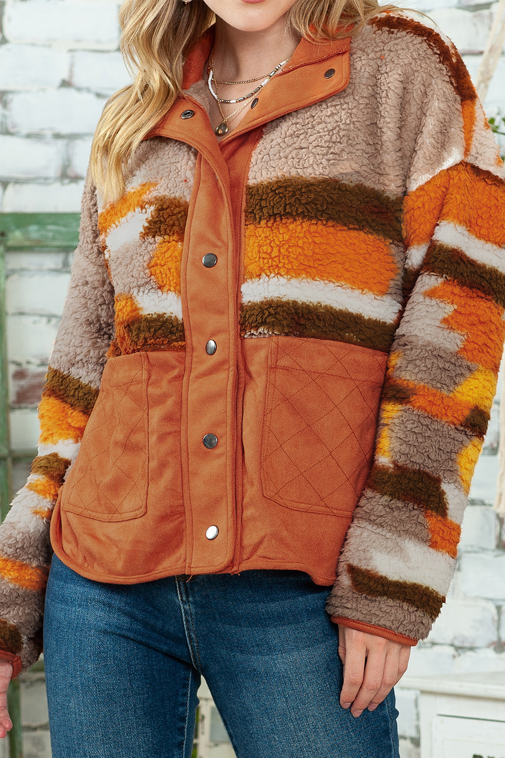 Close-up of the quilted patch pockets on the brown striped and geometric fleece jacket for added style and functionality.