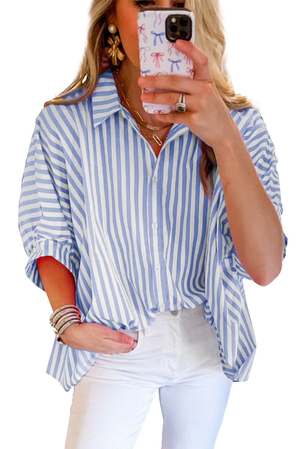 Model wearing a sky blue striped dolman sleeve oversized blouse, showcasing the relaxed and chic style (front view).