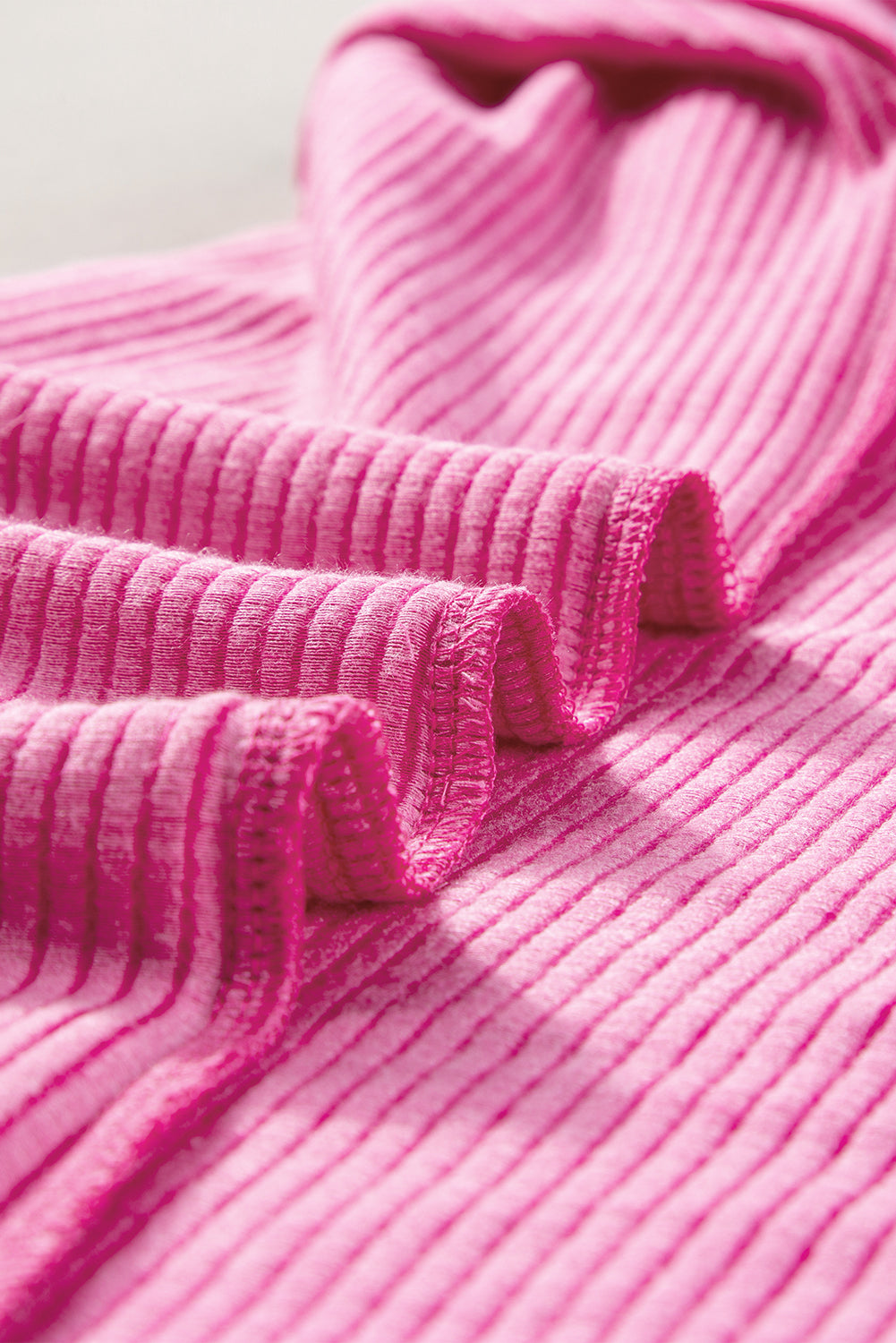 Close-up of the clean finish on the back neckline of the rose red t-shirt dress.