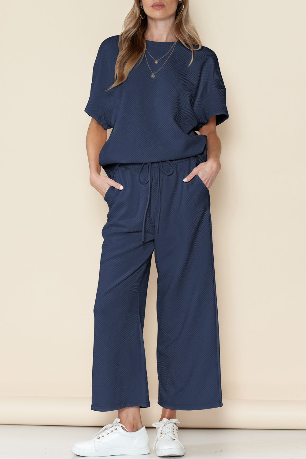 Black textured T-shirt and drawstring pants set: the perfect gift for any occasion.