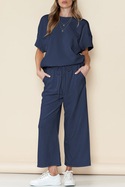 Black textured T-shirt and drawstring pants set: the perfect gift for any occasion.