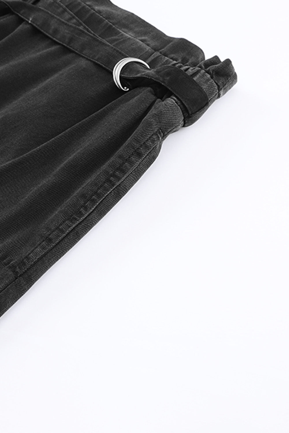 Close-up of the flattering high-waisted silhouette on black pants.