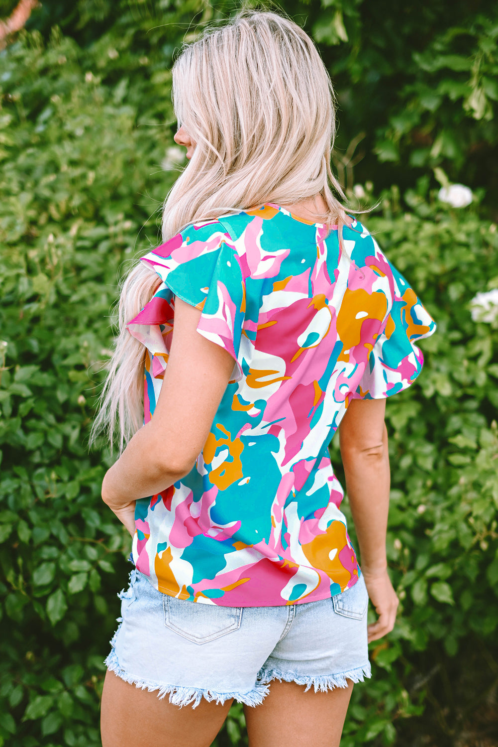 Close-up of the sleeve cuffs on the multicolour abstract print blouse