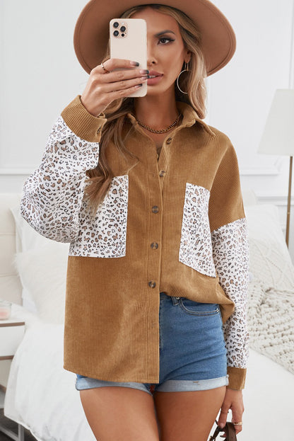 Model walking confidently in a brown button up colorblock pocket corduroy shacket.