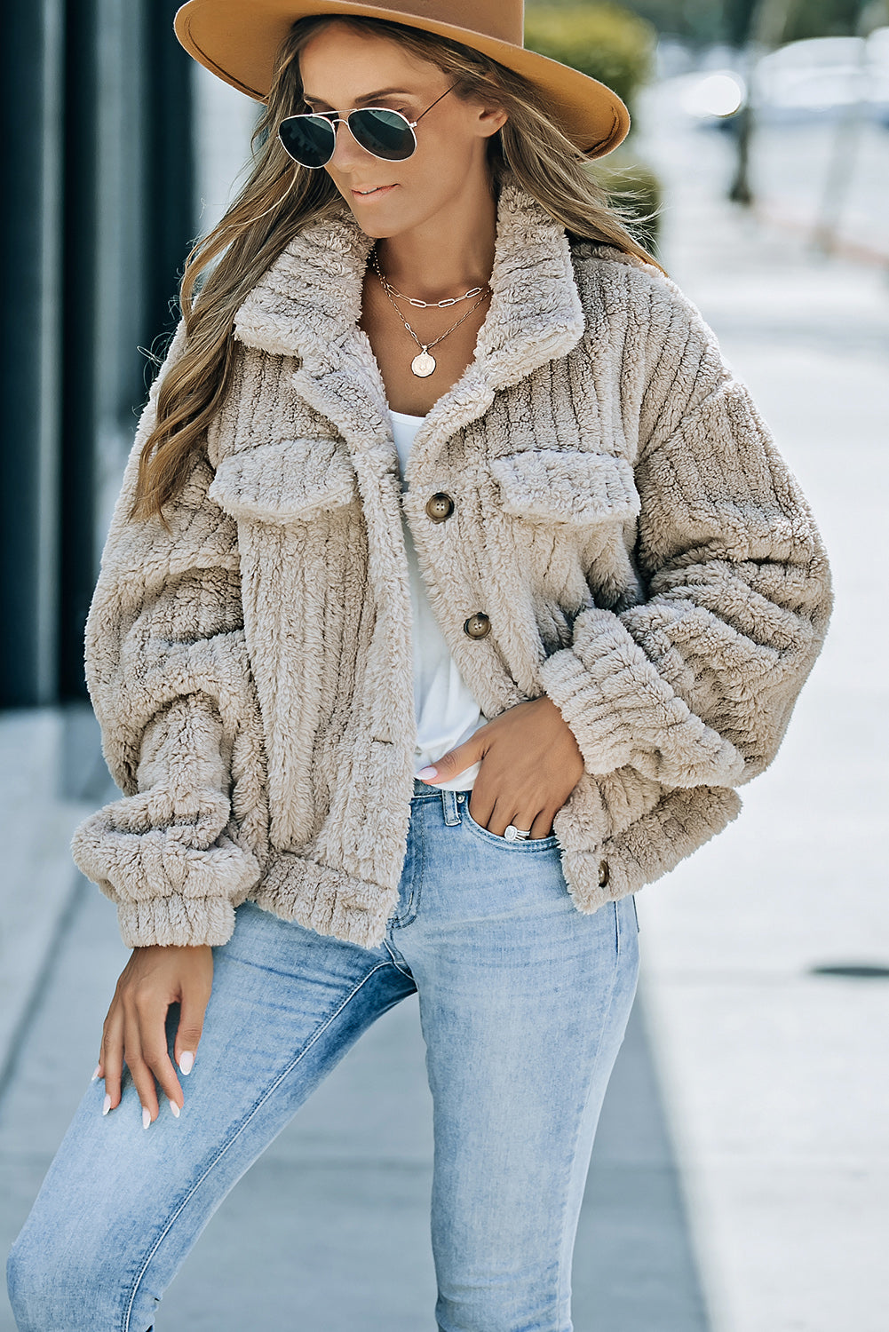 Model wearing a khaki solid color plush fleece button-up jacket (front view).