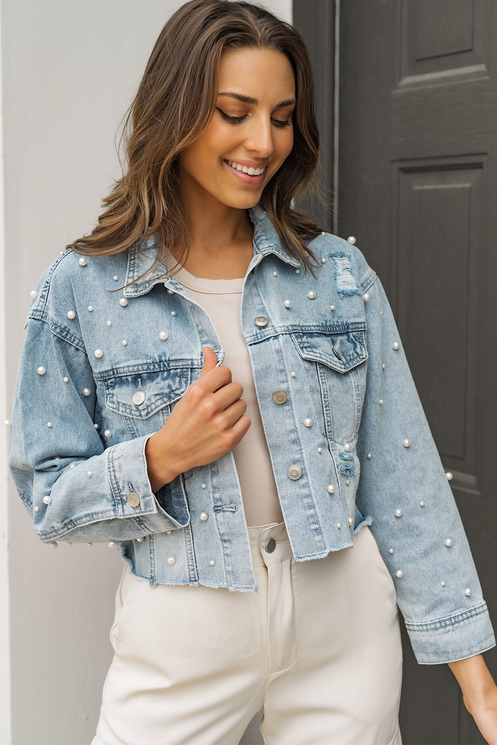 Close-up of the pearl beading embellishments on the jacket, highlighting their design and placement.