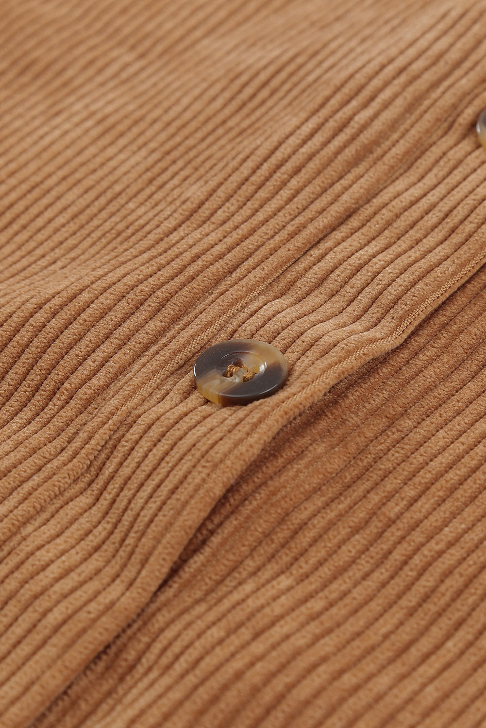 Close-up of the unique leopard print patchwork design on the brown button up colorblock shacket.