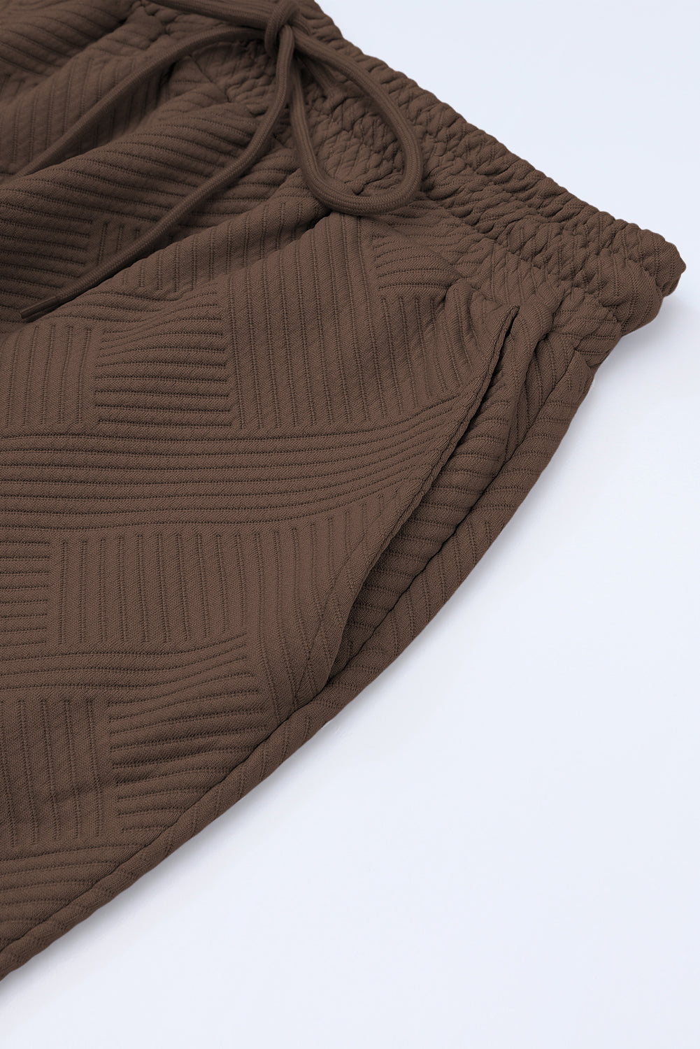 Close-up of the cuffed sleeves on the black textured T-shirt