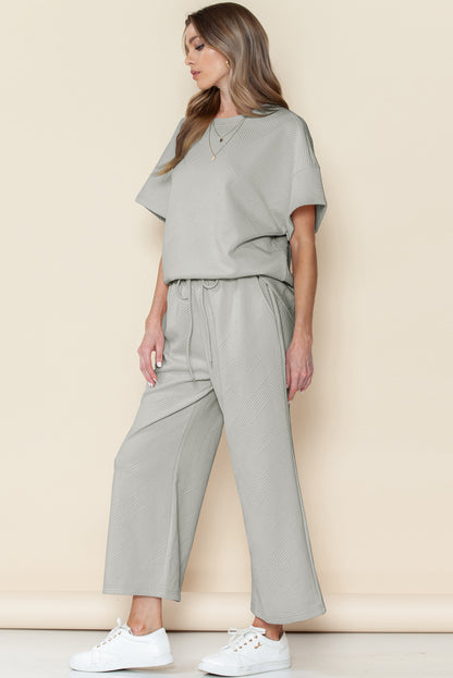 Black textured T-shirt and drawstring pants set: perfect for relaxing at home.