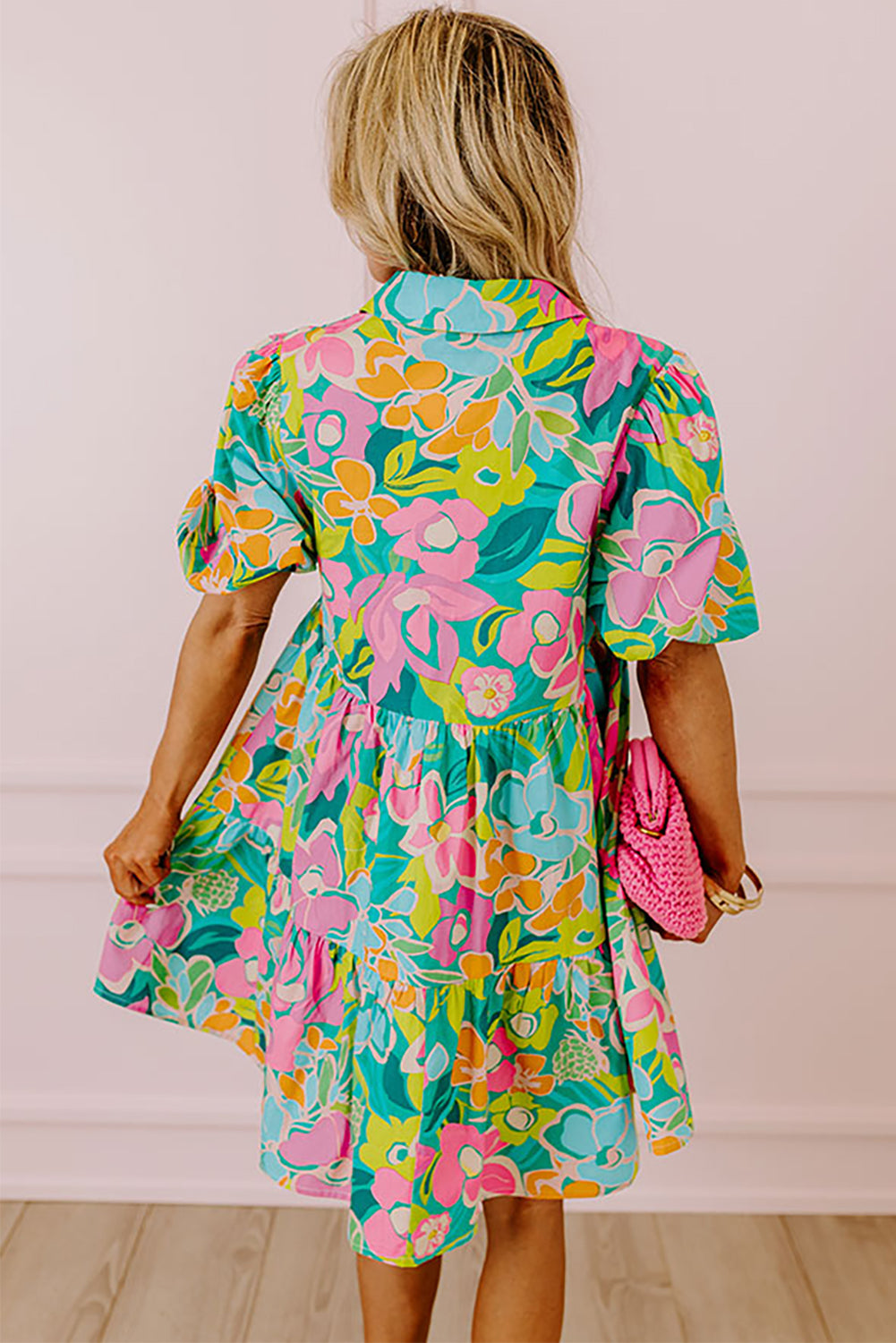 Close-up of the refreshing green color and floral print on the babydoll dress.