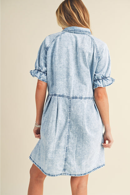 Close-up of the blue mineral wash on the ruffled short sleeve denim dress.