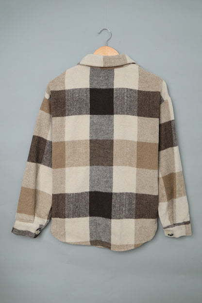 Close-up of the long sleeves and turn-down collar on the khaki plaid shacket.