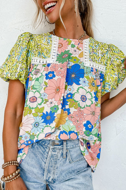 Model wearing a green bubble sleeve lace trim mixed floral blouse (front view).