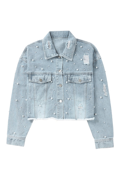 Flat lay image of the cropped denim jacket with other clothing items in similar colors or styles, suggesting outfit ideas.