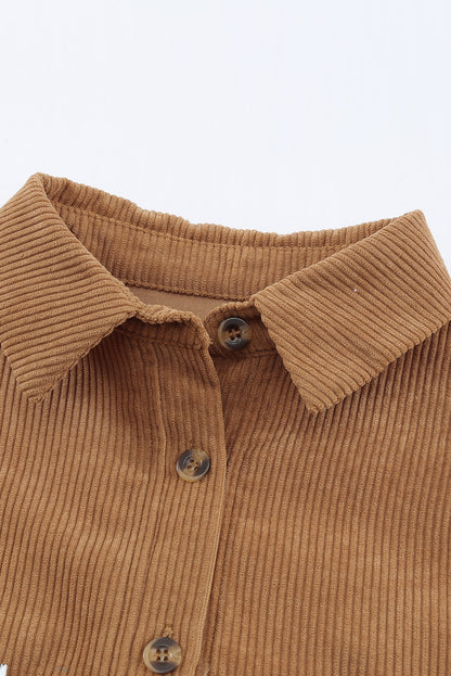 Close-up of the button up closure on the front of the brown colorblock shacket.