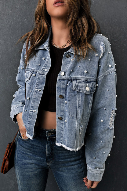 Model wearing the cropped denim jacket over a dress for a more dressed-up outfit.