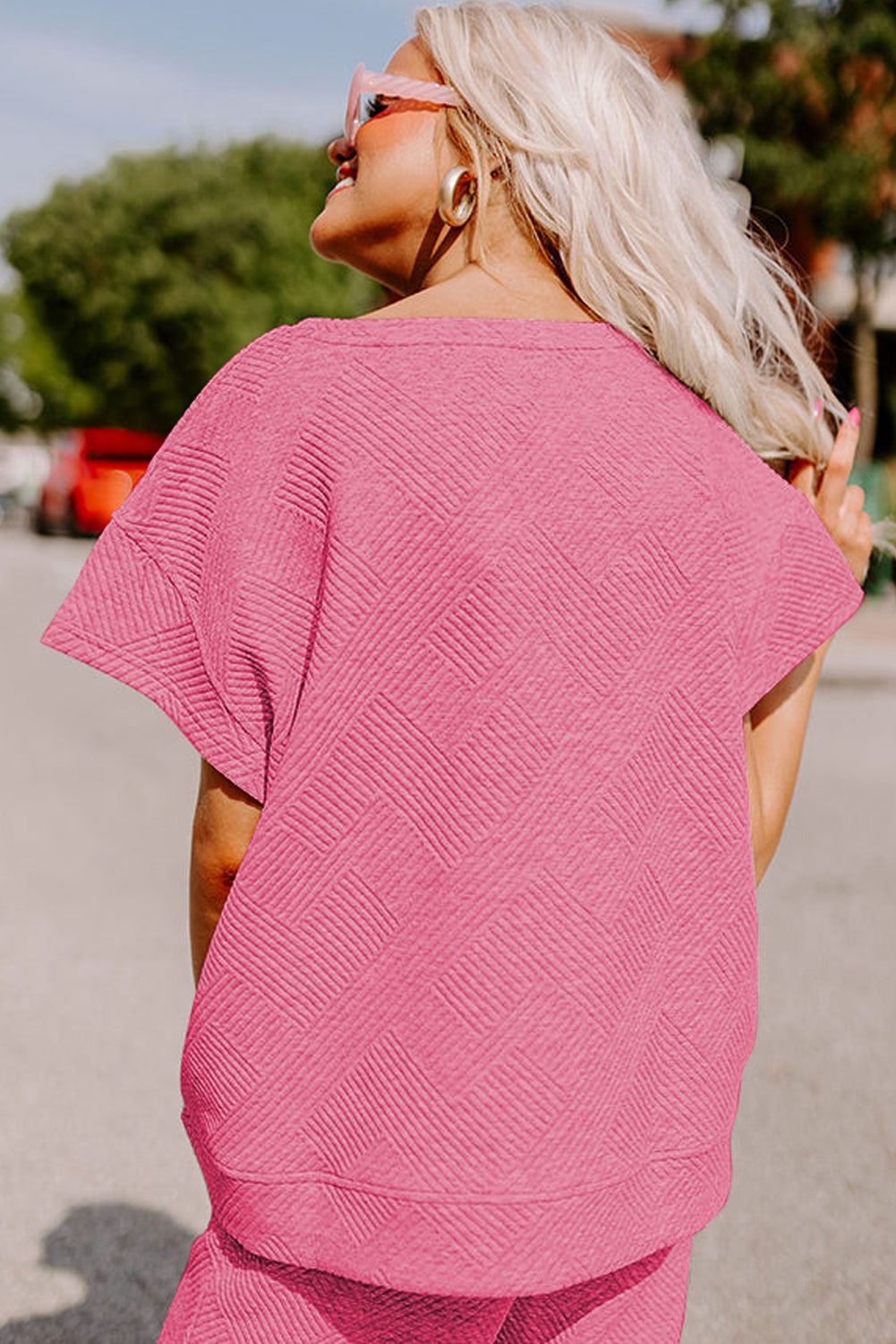 Black textured T-shirt and drawstring pants set: pair it with a hat and sunglasses for a casual day out. (model wearing sunglasses and a hat)