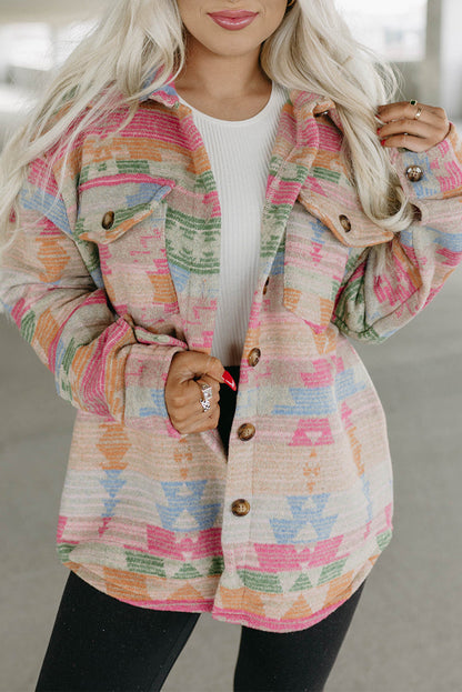 Model confidently walking in a multicolored geometric jacket, paired with jeans and boots (casual outfit).