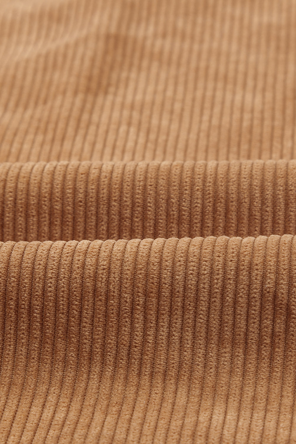 Classic turn-down collar on the brown button up colorblock shacket (close-up).