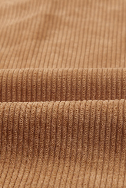 Classic turn-down collar on the brown button up colorblock shacket (close-up).