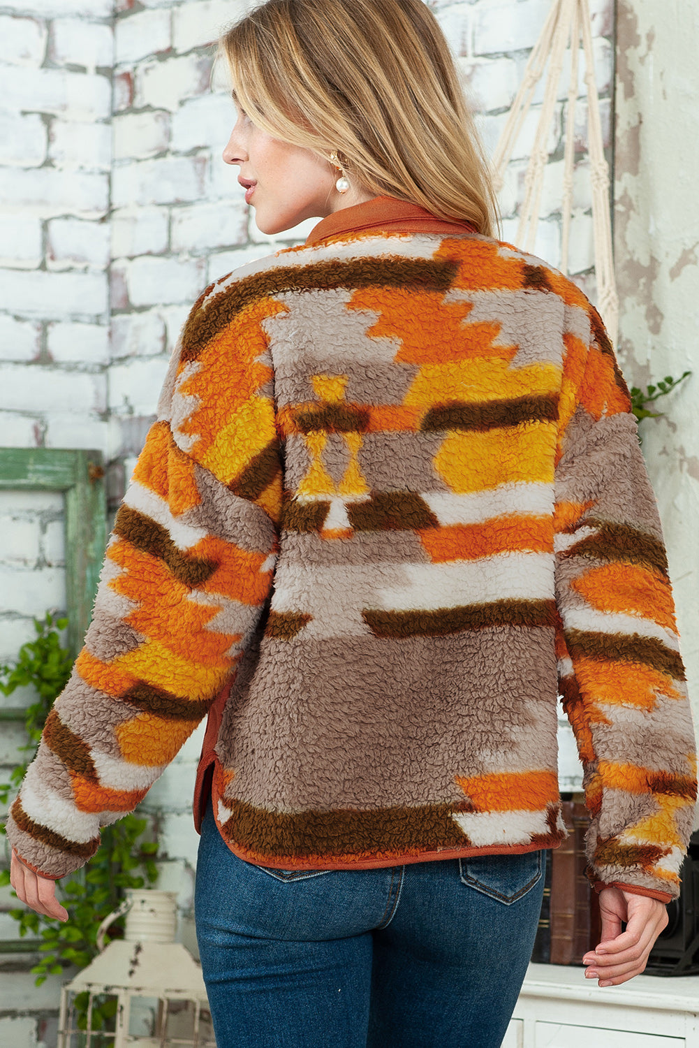 Close-up of the brown striped and geometric fleece fabric on the jacket.