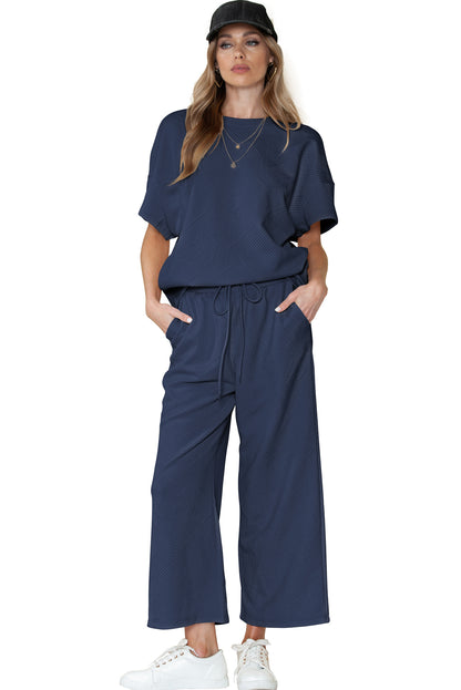 Black textured T-shirt and drawstring pants set: more than just loungewear, it's a lifestyle.