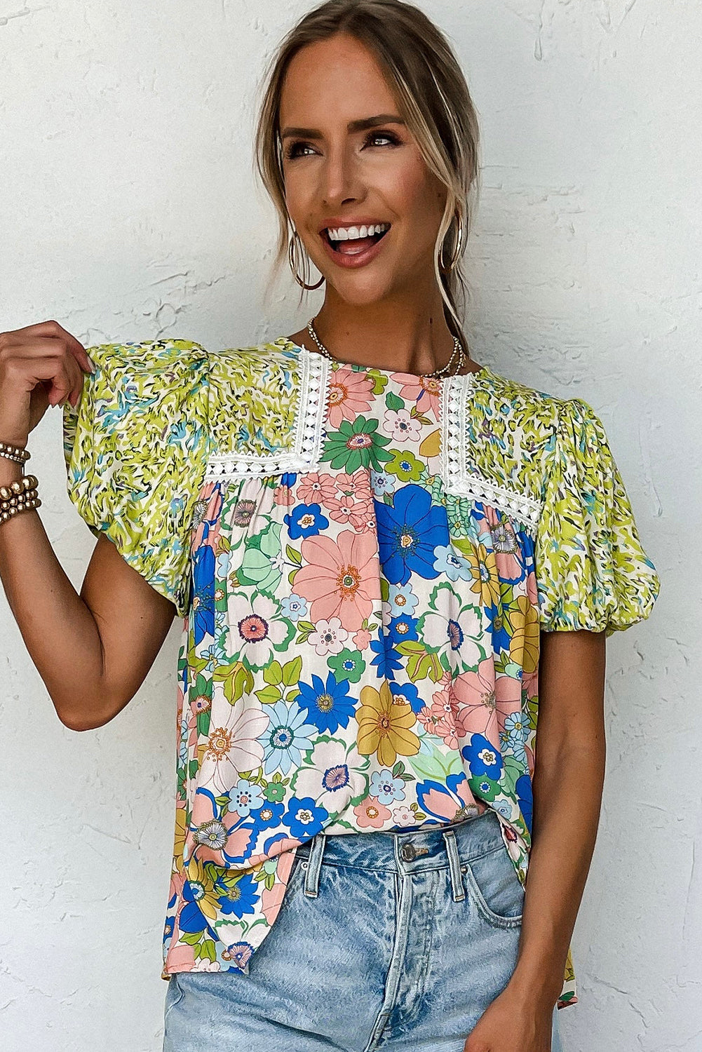 Model walking confidently in a green bubble sleeve lace trim mixed floral blouse.