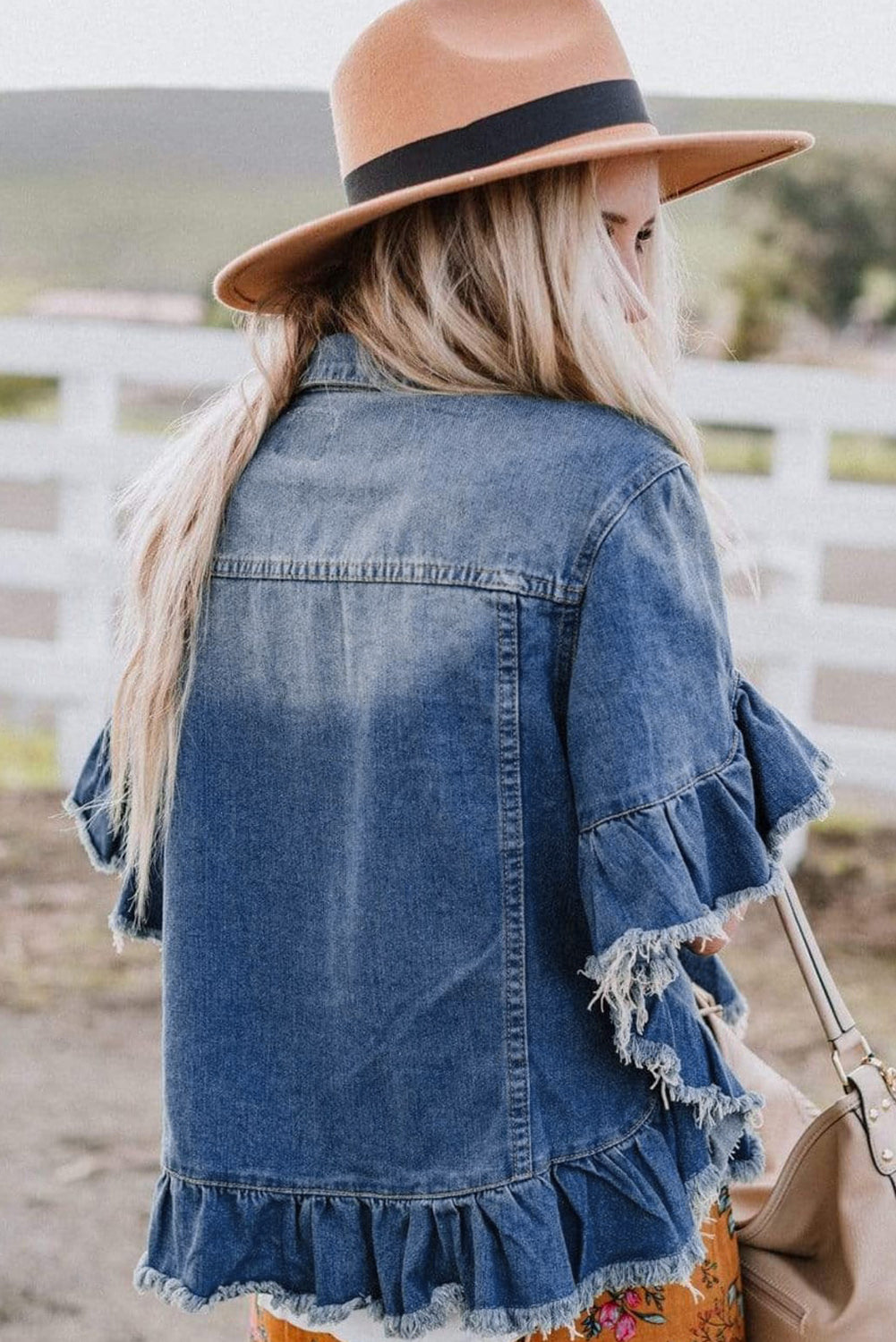 Close-up of the unique peacock blue color wash on the denim jacket.