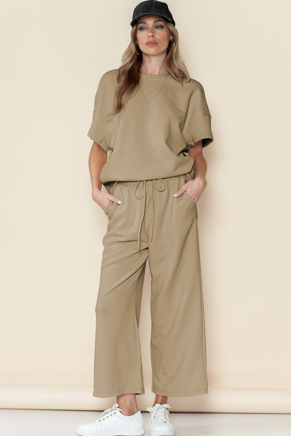 Black textured T-shirt and drawstring pants set: comfortable enough for long walks or hikes. (model walking in nature)