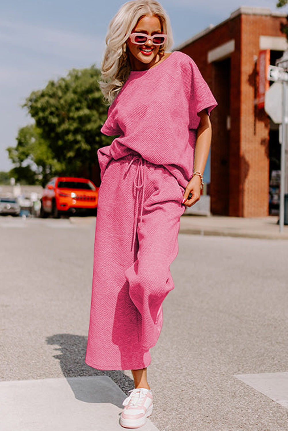 Black textured T-shirt and drawstring pants set: the perfect outfit for a casual picnic in the park. (couple having a picnic)