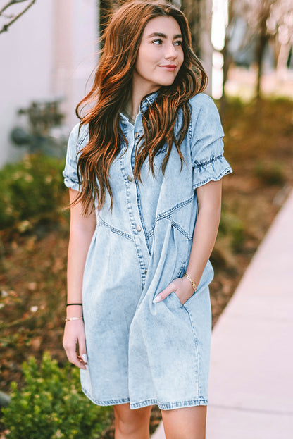 Model enjoying a coffee outdoors in a blue mineral washed denim dress with ruffled short sleeves and pockets.