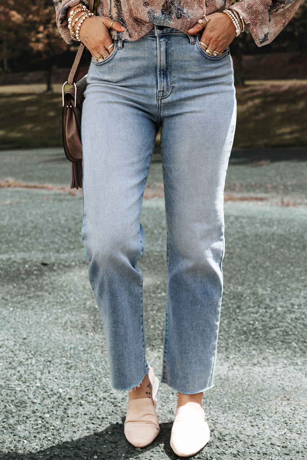 Light blue acid wash straight leg jeans with raw edge (women's denim).