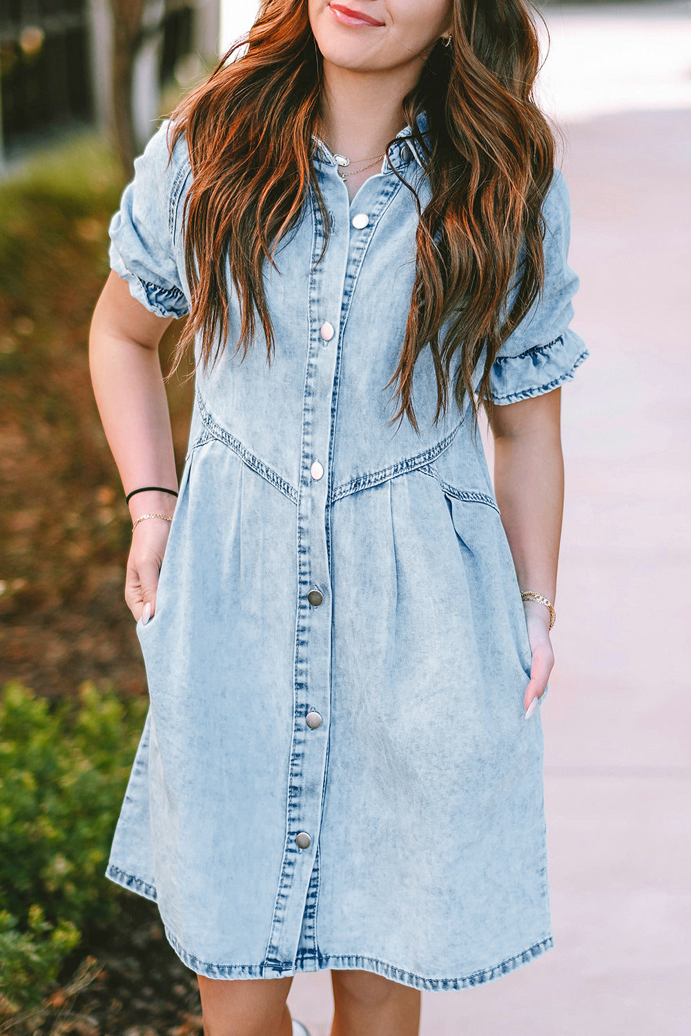 Side pockets on the blue mineral washed denim dress for added functionality.