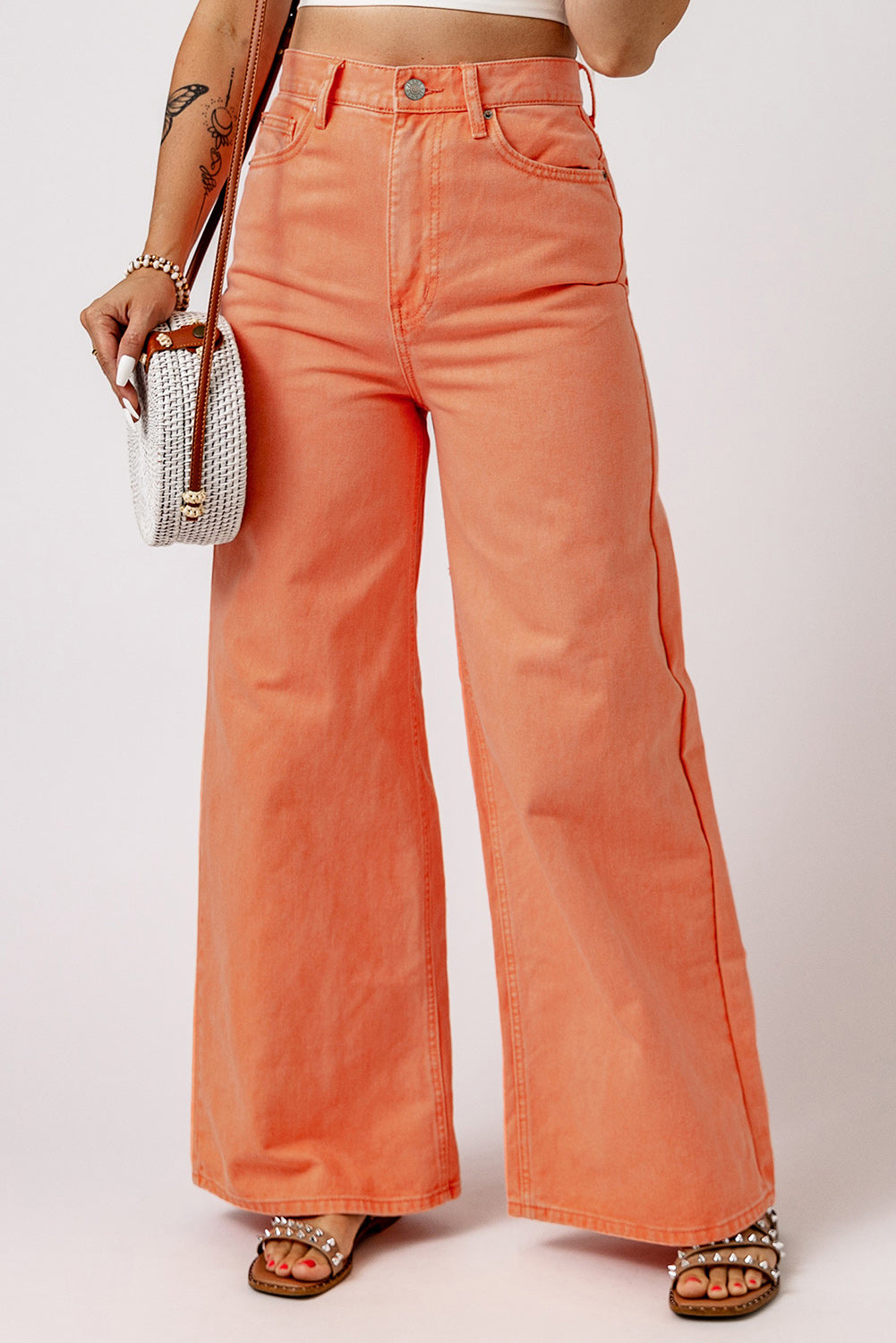 Orange acid wash jeans with a high waist and wide leg design (women's jeans).